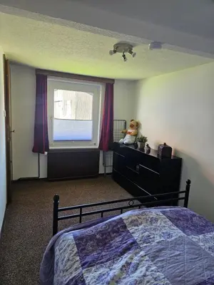Ein Bett oder Betten in einem Zimmer der Unterkunft Ferienwohnung zu den Blauen Schafen