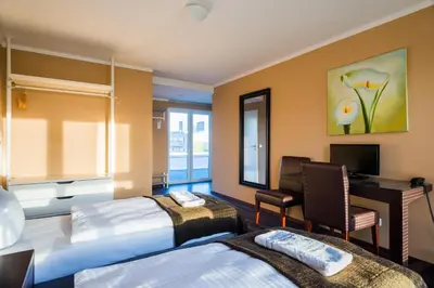 Ein Bett oder Betten in einem Zimmer der Unterkunft Apple City Hotel
