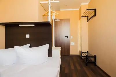 Ein Bett oder Betten in einem Zimmer der Unterkunft Apple City Hotel