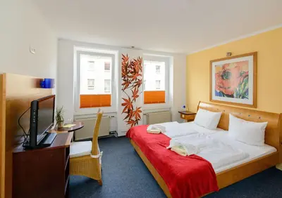 Ein Bett oder Betten in einem Zimmer der Unterkunft City Hotel-Pension Brandenburg