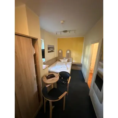 Ein Bett oder Betten in einem Zimmer der Unterkunft Pension Sanssouci