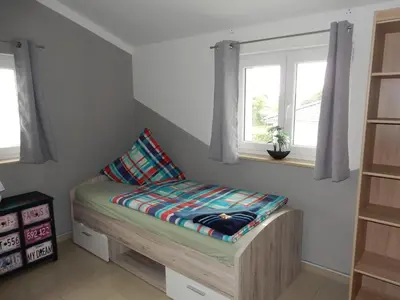 Ein Bett oder Betten in einem Zimmer der Unterkunft Apartment Haus 25