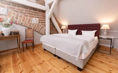 Ein Bett oder Betten in einem Zimmer der Unterkunft Up Hus Hotel Neuruppin