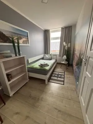 Ein Bett oder Betten in einem Zimmer der Unterkunft Ferienwohnung zur alten Waage