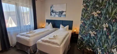 Ein Bett oder Betten in einem Zimmer der Unterkunft BusinessHotel Mühlenbeck
