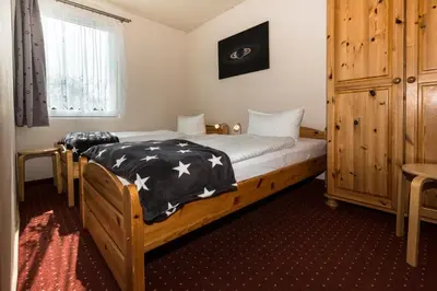 Ein Bett oder Betten in einem Zimmer der Unterkunft Ferienhaus Saturn