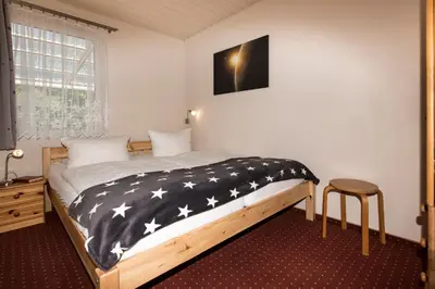 Ein Bett oder Betten in einem Zimmer der Unterkunft Ferienhaus Jupiter