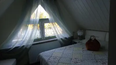 Ein Bett oder Betten in einem Zimmer der Unterkunft Ferienhaus Rose & Lavendel