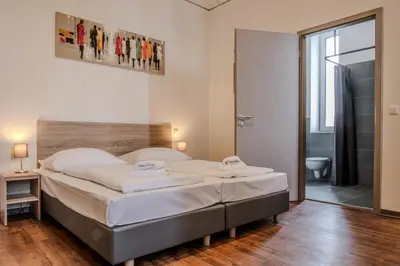 Ein Bett oder Betten in einem Zimmer der Unterkunft Queens Residenz