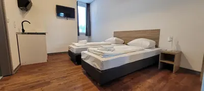 Ein Bett oder Betten in einem Zimmer der Unterkunft Queens Residenz