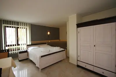 Ein Bett oder Betten in einem Zimmer der Unterkunft Hotel Da Gianni GmbH