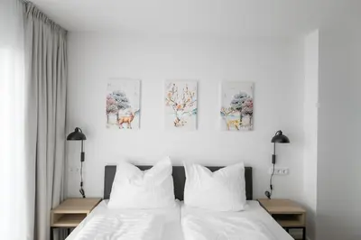 Ein Bett oder Betten in einem Zimmer der Unterkunft Helios Berlin Apartments