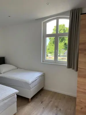 Ein Bett oder Betten in einem Zimmer der Unterkunft Remise 23a - 2Schlafzimmer Unterkunft für 4-köpfige Familie