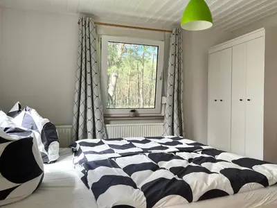 Ein Bett oder Betten in einem Zimmer der Unterkunft Ferienhaus im Wald, am Briesener See