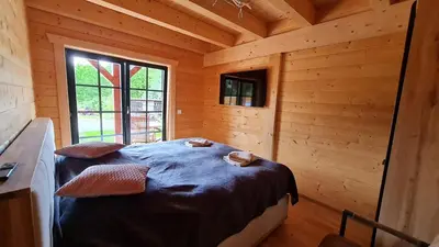 Ein Bett oder Betten in einem Zimmer der Unterkunft Blockhaus an der Dahme , Ferienhaus