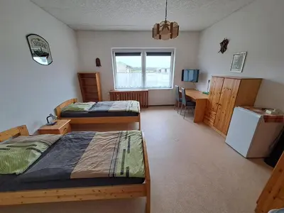 Ein Bett oder Betten in einem Zimmer der Unterkunft Ingos Landhaus