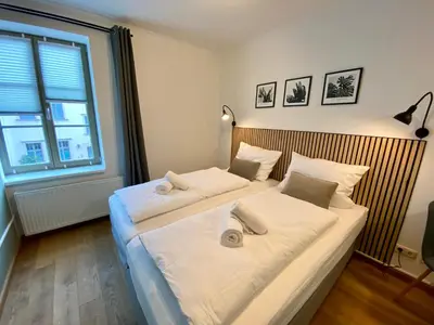 Ein Bett oder Betten in einem Zimmer der Unterkunft Apartments am Markt