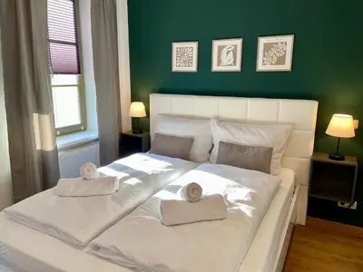 Ein Bett oder Betten in einem Zimmer der Unterkunft Apartments am Markt