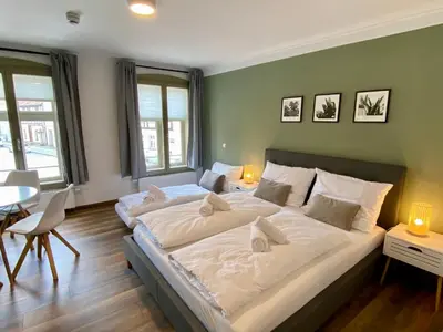 Ein Bett oder Betten in einem Zimmer der Unterkunft Apartments am Markt
