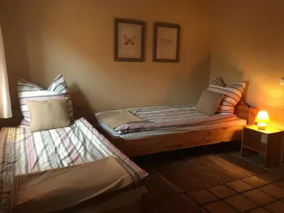 Ein Bett oder Betten in einem Zimmer der Unterkunft Stilvolle Gästezimmer auf romantischem Pferdehof