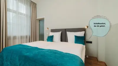 Ein Bett oder Betten in einem Zimmer der Unterkunft H24 Hotel Apartments Eberswalde