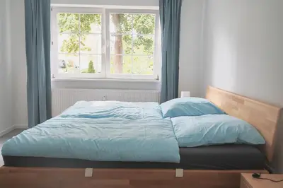 Ein Bett oder Betten in einem Zimmer der Unterkunft Vereinbarkeit Familie und Beruf