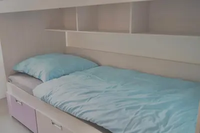 Ein Bett oder Betten in einem Zimmer der Unterkunft Vereinbarkeit Familie und Beruf