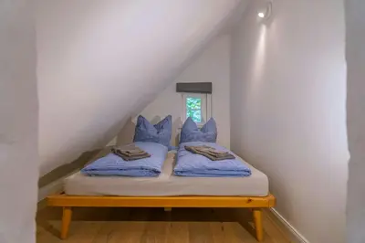 Ein Bett oder Betten in einem Zimmer der Unterkunft Historic Forester's House Tornow In Forest Setting