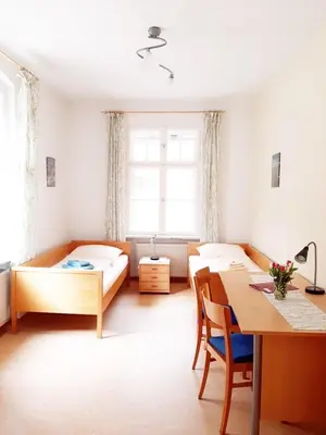 Ein Bett oder Betten in einem Zimmer der Unterkunft Die Malche Gäste und Tagungshaus 26