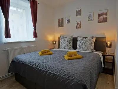 Ein Bett oder Betten in einem Zimmer der Unterkunft HOGULU - 3 - RAUM - App 25 mit Balkon