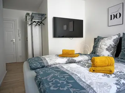 Ein Bett oder Betten in einem Zimmer der Unterkunft Hogulu - unweit der Jahrtausendbrücke Appartement 8