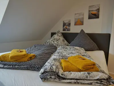 Ein Bett oder Betten in einem Zimmer der Unterkunft Hogulu - gemütliches Appartement 17 direkt in der Altstadt