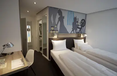 Ein Bett oder Betten in einem Zimmer der Unterkunft Grimm's Potsdamer Platz
