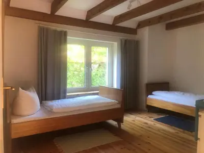 Ein Bett oder Betten in einem Zimmer der Unterkunft Bruderhof - Retreats & Ferien am See nahe Berlin