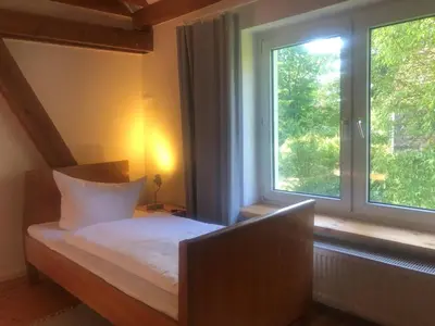 Ein Bett oder Betten in einem Zimmer der Unterkunft Bruderhof - Retreats & Ferien am See nahe Berlin