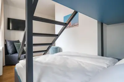 Ein Bett oder Betten in einem Zimmer der Unterkunft Homaris Nolli Studios
