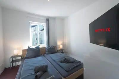 Ein Bett oder Betten in einem Zimmer der Unterkunft Urbanes Dachrefugium mit Balkon