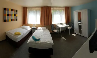 Ein Bett oder Betten in einem Zimmer der Unterkunft Apartmentpension Am Krongut