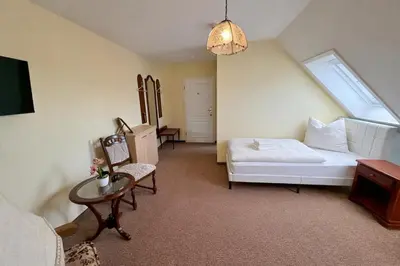 Ein Bett oder Betten in einem Zimmer der Unterkunft Schlösschen am Rhinufer