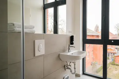 Ein Badezimmer in der Unterkunft Homaris Rummelsburg Studios