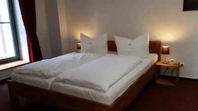 Ein Bett oder Betten in einem Zimmer der Unterkunft Pension Am Dorfanger