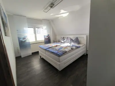 Ein Bett oder Betten in einem Zimmer der Unterkunft Leuchtturmhus
