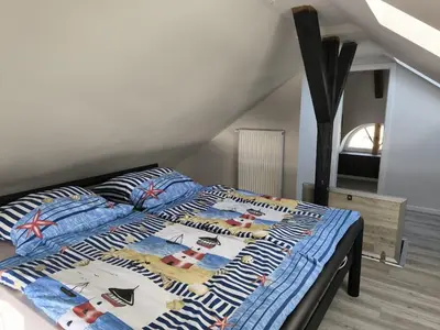 Ein Bett oder Betten in einem Zimmer der Unterkunft Leuchtturmhus