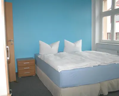 Ein Bett oder Betten in einem Zimmer der Unterkunft Lindencafe Luckenwalde