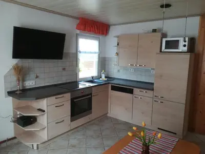 Küche/Küchenzeile in der Unterkunft Spreewaldhäuser Golinski mit Kamin am Neuendorfer See