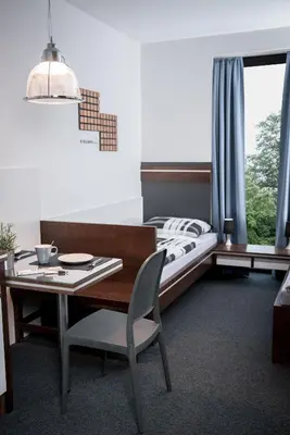 Ein Bett oder Betten in einem Zimmer der Unterkunft Triumph Inn Pension