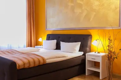 Ein Bett oder Betten in einem Zimmer der Unterkunft Hotel Spreewitz am Kurfürstendamm