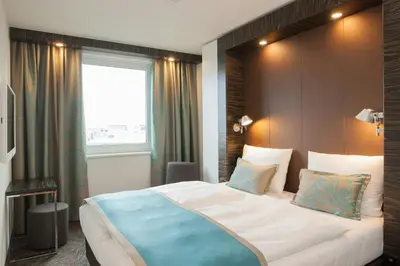 Ein Bett oder Betten in einem Zimmer der Unterkunft Motel One Berlin-Tiergarten