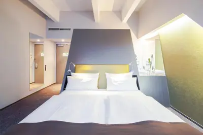 Ein Bett oder Betten in einem Zimmer der Unterkunft Aspria Berlin Ku'damm Sport & Spa