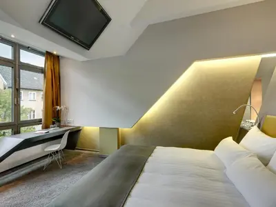Ein Bett oder Betten in einem Zimmer der Unterkunft Aspria Berlin Ku'damm Sport & Spa